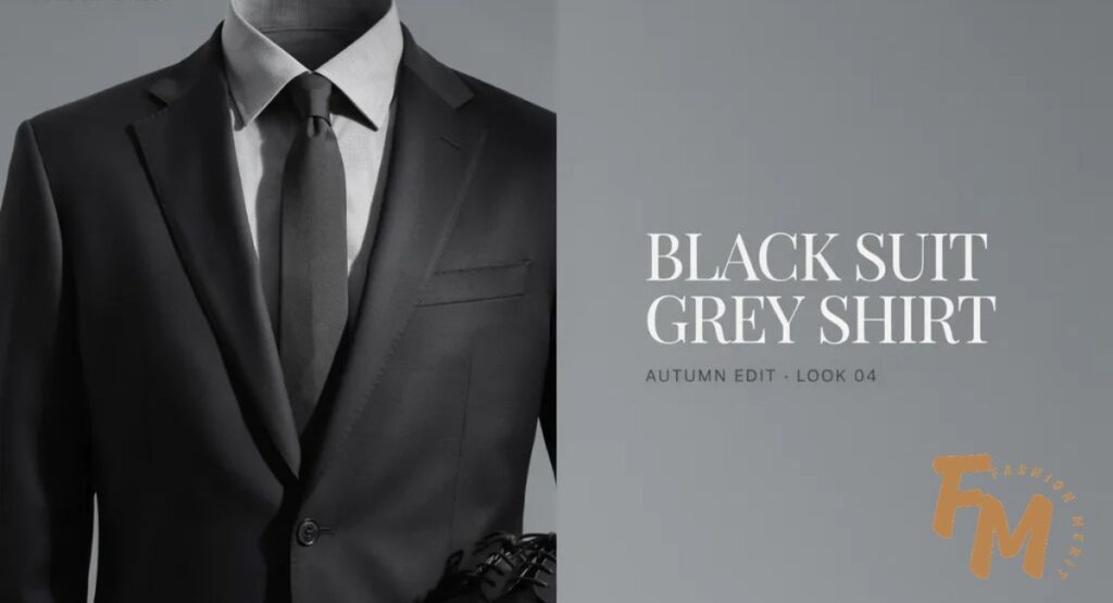 Business professional in a black suit and grey shirt during a corporate meeting.