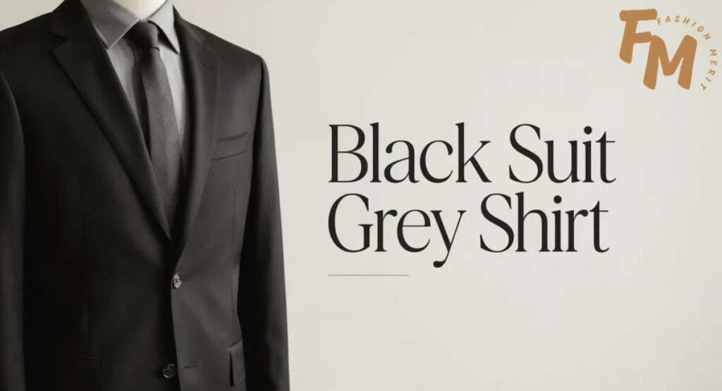 Man wearing a black suit with a light grey dress shirt and black tie.